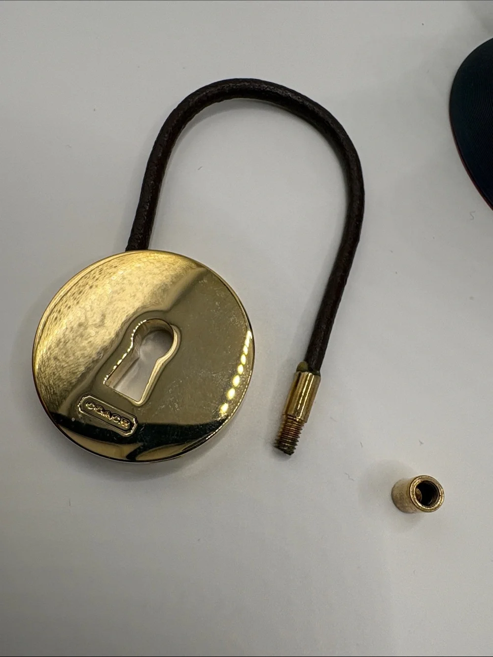Coach Gold-Tone Padlock Charm on Brown Leather Loop